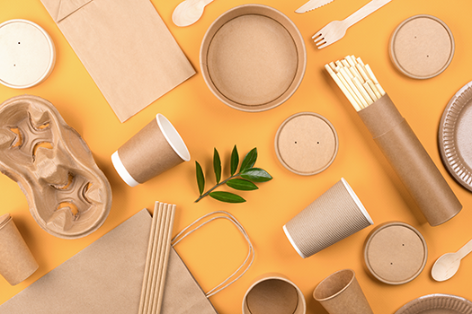 cardboard and paper packaging on orange background